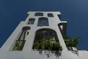 Light-Filled Tube House: Discover Unique Arched Facade & Green Urban Living-9