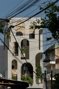 Light-Filled Tube House: Discover Unique Arched Facade & Green Urban Living-6