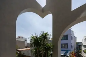 Light-Filled Tube House: Discover Unique Arched Facade & Green Urban Living-0