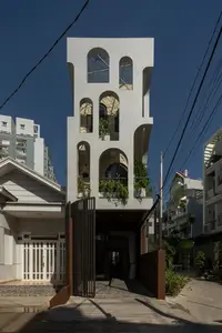 Light-Filled Tube House: Discover Unique Arched Facade & Green Urban Living-4