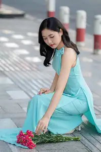 Charming Vietnamese Girl in Turquoise Ao Dai: Elegant Beauty on City Streets-1