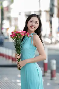 Charming Vietnamese Girl in Turquoise Ao Dai: Elegant Beauty on City Streets-2