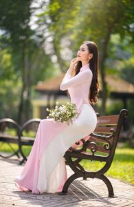Elegant Vietnamese Woman in Pink Ao Dai Gracing a Sunny Park-5