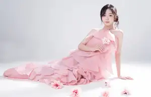 Discover Feminine Elegance: A Girl in a Pink Dress with Pristine Flowers-3