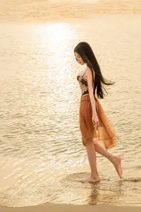 Golden Hour Serenity: Young Woman's Graceful Beach Walk-0