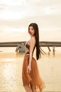 Golden Hour Serenity: Young Woman's Graceful Beach Walk-4