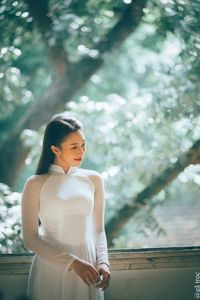 Graceful Vietnamese Girl in White Ao Dai by Window, Celebrating Traditional Beauty-13