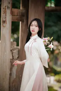 Timeless Elegance: Vietnamese Woman in Traditional Ao Dai Amidst Serene Backdrop-0