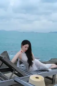 Elegant Beauty on the Waves: White Dress Muse Cruises the Azure Sea-2