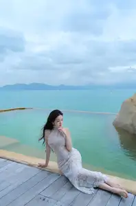 Elegant Beauty on the Waves: White Dress Muse Cruises the Azure Sea-4