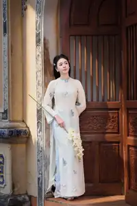 Graceful Ao Dai: The Ethereal Beauty of a Vietnamese Woman with White Orchids, Inspiring Tradition.-7