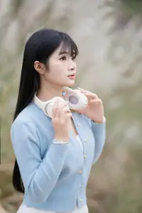 Explore Serene Beauty: Long-Haired Girl Immersed in Music Amidst Pampas Grass-1