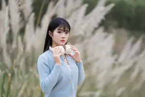 Explore Serene Beauty: Long-Haired Girl Immersed in Music Amidst Pampas Grass-4