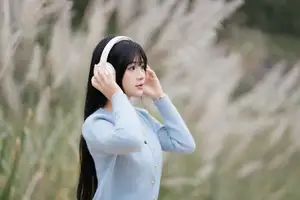 Explore Serene Beauty: Long-Haired Girl Immersed in Music Amidst Pampas Grass-0