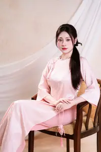 Vietnamese Beauty: Graceful in Traditional Pink Ao Dai and Conical Hat-1