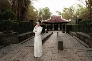 Gentle Elegance: Vietnamese Girl in Pure White Ao Dai with Hair Flowers - Traditional Beauty.-10