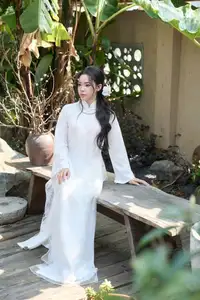 Elegant White Ao Dai: Pure Beauty of Vietnamese Woman with Pristine Orchids.-10