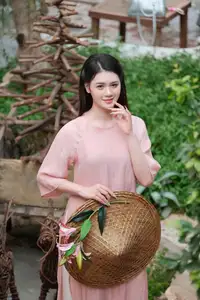 Discover Serene Vietnamese Beauty: Elegant Woman in Pink Linen Dress Amidst Floral Charm-4