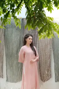 Discover Serene Vietnamese Beauty: Elegant Woman in Pink Linen Dress Amidst Floral Charm-1