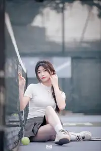 Pensive Break on Court: Young Tennis Player Recharges Energy After Intense Training Session-2