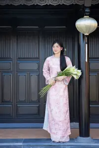 Graceful Asian Lady in Pink Ao Dai with Pristine White Lilies in Traditional Setting-1