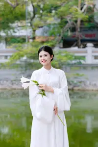 Graceful Vietnamese Beauty: A Serene Woman in White with a Lily-1