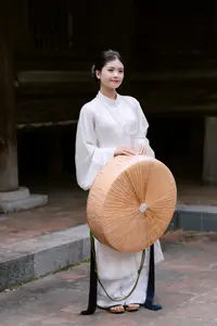 Graceful Vietnamese Beauty: A Serene Woman in White with a Lily-2
