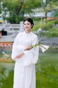 Graceful Vietnamese Beauty: A Serene Woman in White with a Lily-5
