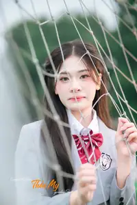 Cute Schoolgirl Frames a Moment on Green Grass-9