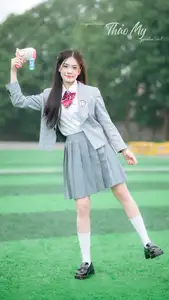 Cute Schoolgirl Frames a Moment on Green Grass-3