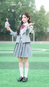 Cute Schoolgirl Frames a Moment on Green Grass-4