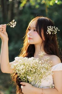 Captivating Portrait: Gentle Girl's Natural Beauty with Pure White Flowers in Golden Sunlight. Discover Her Grace.-9