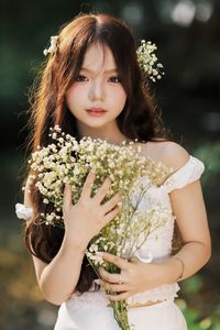 Captivating Portrait: Gentle Girl's Natural Beauty with Pure White Flowers in Golden Sunlight. Discover Her Grace.-8