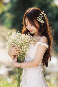 Captivating Portrait: Gentle Girl's Natural Beauty with Pure White Flowers in Golden Sunlight. Discover Her Grace.-1