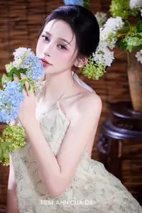 Ethereal Vietnamese Beauty: Graceful Asian Girl in Modern Yếm with Delicate Blooms.-0