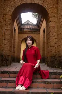 Discover the Timeless Elegance of a Vietnamese Woman in Red Ao Dai at Ancient Architecture.-7