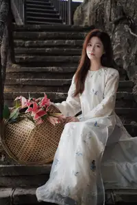 Elegant Vietnamese Beauty in White Ao Dai Serene Portrait with Pink Lilies on Ancient Stone Steps-0