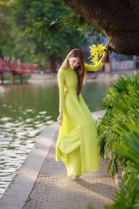 Serene Vietnamese Beauty: Woman in Ao Dai by the Lake-11