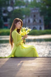 Serene Vietnamese Beauty: Woman in Ao Dai by the Lake-7