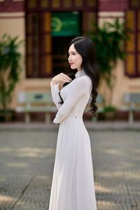 Captivating White Ao Dai: Elegant Vietnamese Girl in a Serene Moment, Timeless Beauty. Image ID: 1000019816.-2